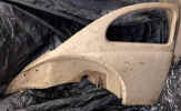 NOS_VW_beetle_rear_quarter_panel_complete_small_window_semaphore_hole_oval_early_rare_111809086A__1.JPG (190659 bytes)